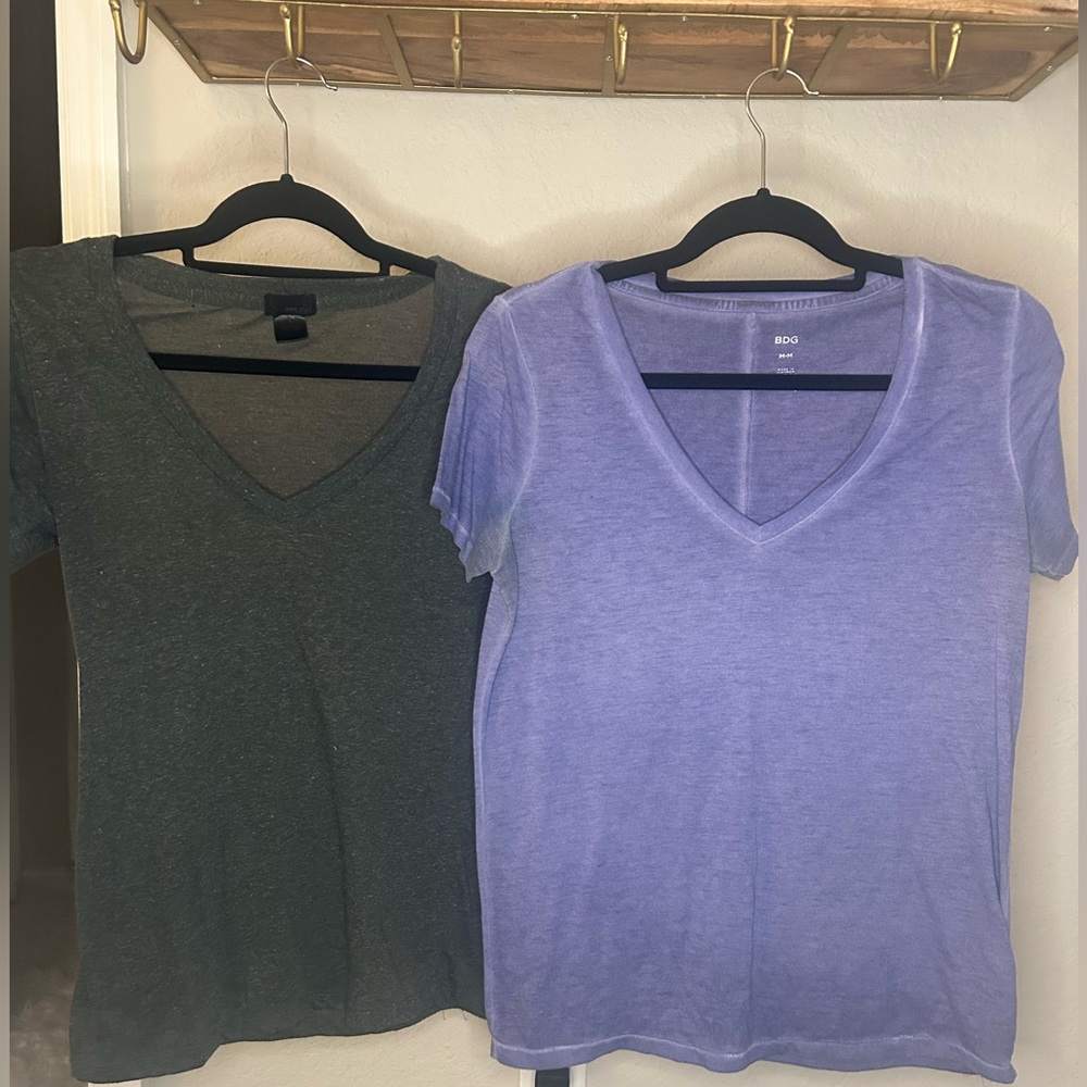 A set of grey and purple v neck shirts